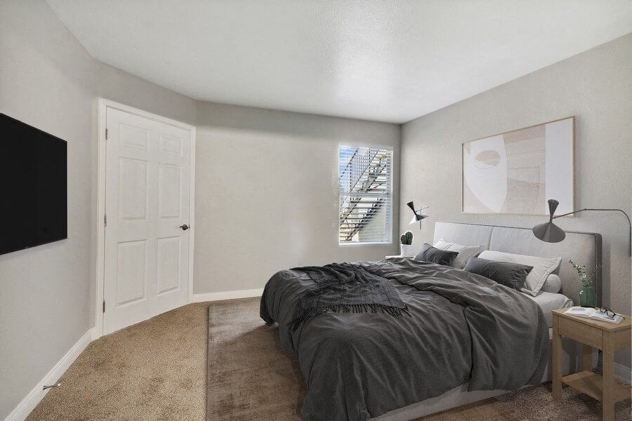 Model bedroom with a bed and a window