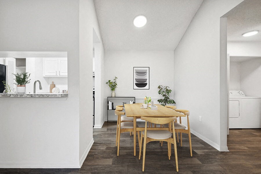 Model Dining Room and Kitchen with Wood-Style Flooring at Rosehill Preserve Apartments located in Orlando, FL.