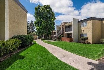 Apartment complex exterior showcasing walking path