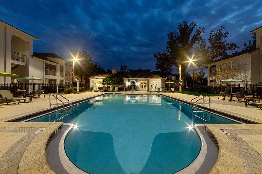 Community Swimming Pool with Pool Furniture at Vinings at Hunter's Green Apartments in Tampa, FL.