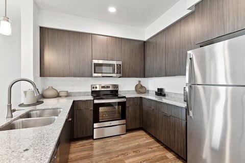 a kitchen with stainless steel appliances and wooden cabinets