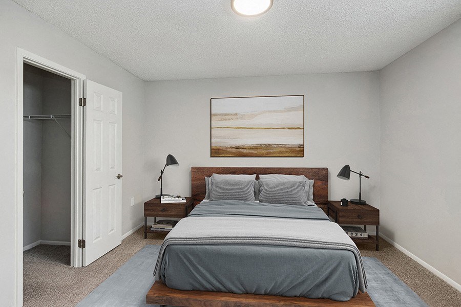 Model Bedroom with Carpet and Closet at Parc at Creekside Apartments in Kansas City, MO.