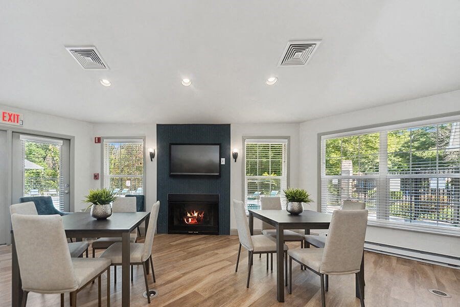 Community Clubhouse with Lounge Furniture and Fireplace at The Commons at Haynes Farm Apartments in Boston, MA.