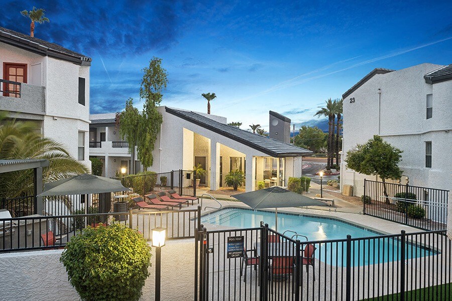 Aerial View of Community Swimming Pool and Pool Furniture at Crystal Creek Apartments located in Phoenix, AZ.