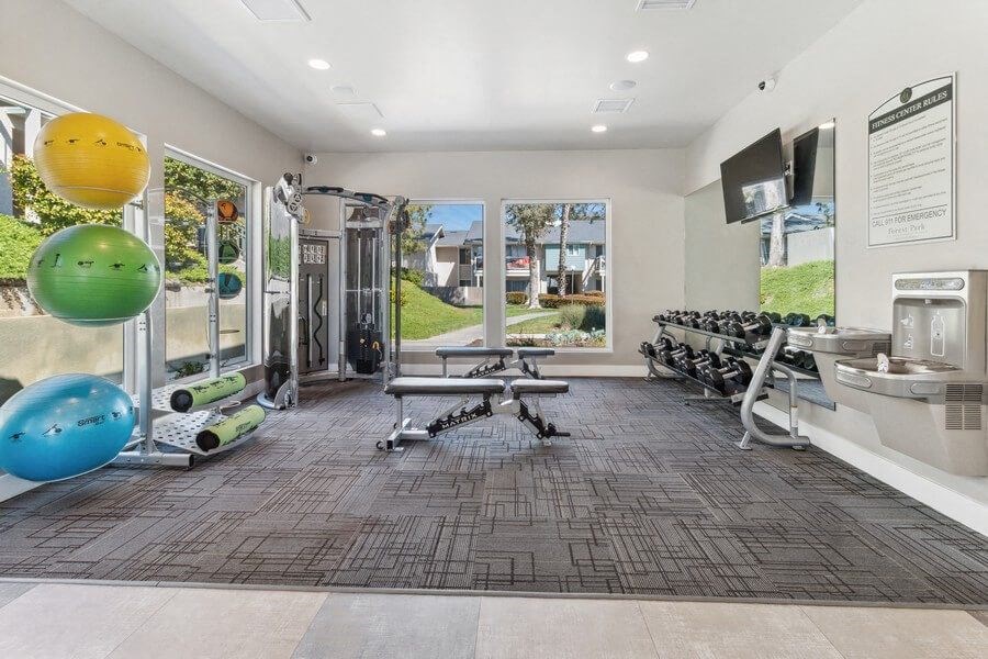 Community Fitness Center with Equipment, Drinking Fountain & Window View at Forest Park Apartments in El Cajon, CA.