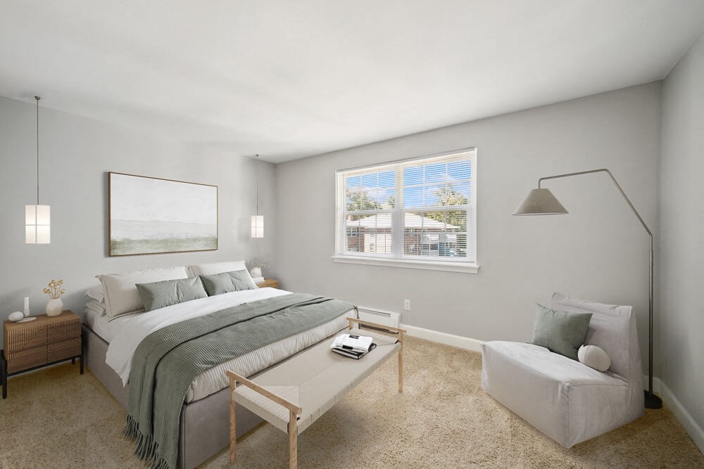 a bedroom with gray walls and a large window