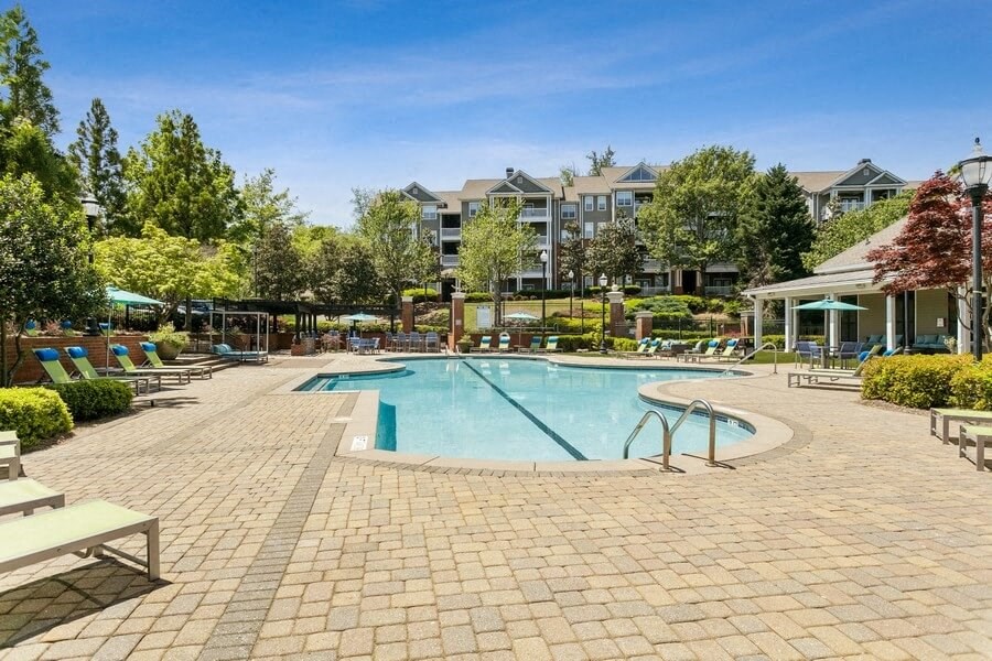 Swimming pool with cabanas and lounge chairs