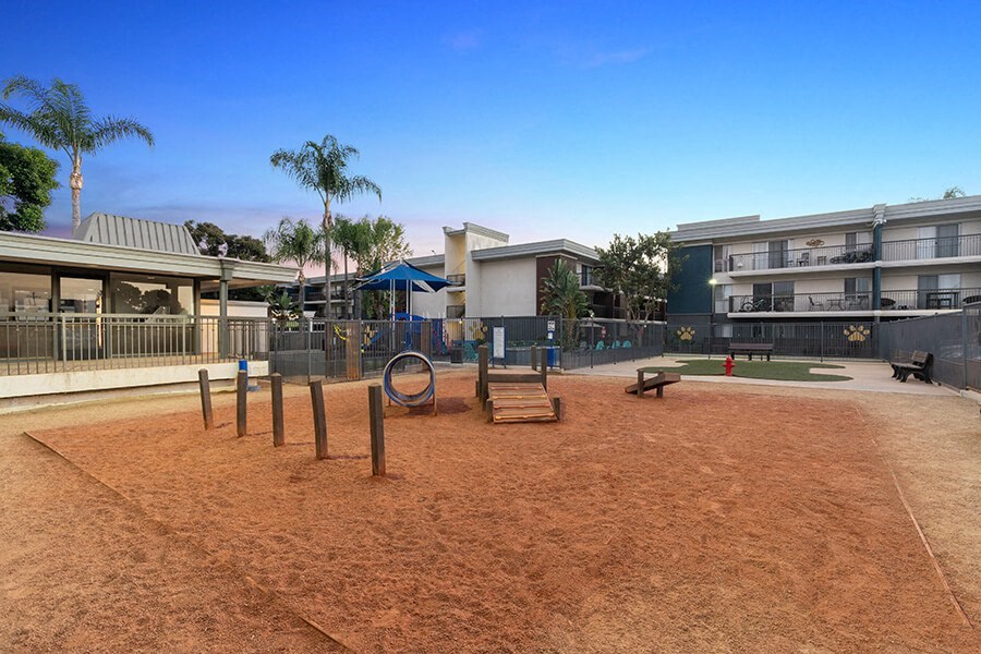 Community Dog Park with Agility Equipment at Madison Park Apartments located in Anaheim, CA.