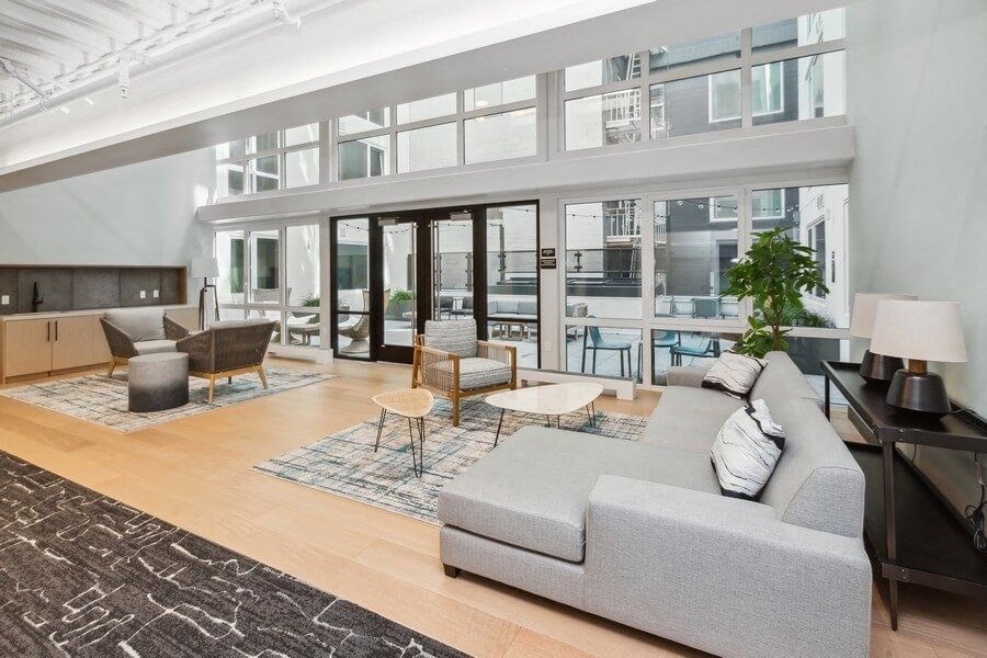 Interior lounge with large sun windows at TL Residences