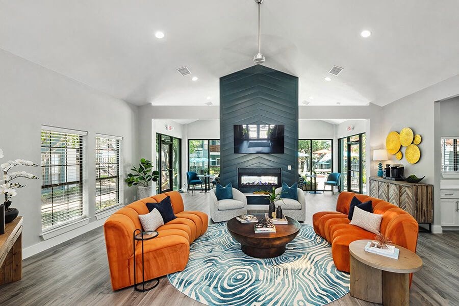 Community Clubhouse with Lounge Furniture and Fireplace at Bridges at Deer Run Apartments in Dallas, TX.