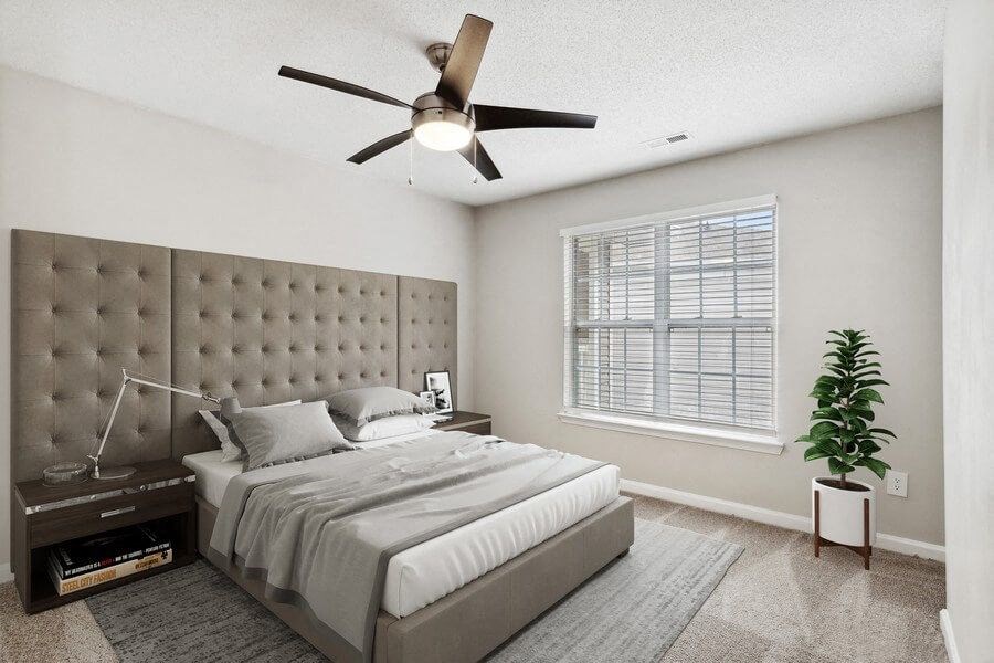 Model bedroom with ceiling fan at Retreat at Stonecrest Apartments