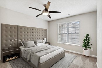 Model bedroom with ceiling fan at Retreat at Stonecrest Apartments - Photo Gallery 10