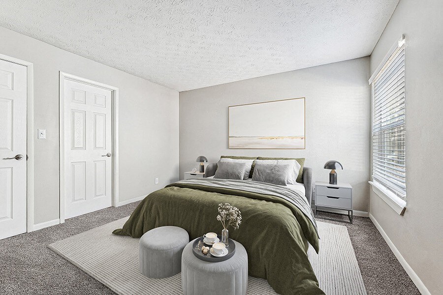 Model Bedroom with Carpet and Window View at Paramont Apartments in Duluth, GA.