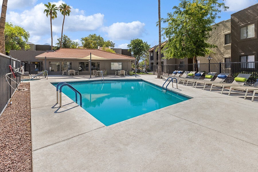 Community Swimming Pool with Pool Furniture at Saddle Ridge Apartments in Tucson, AZ.