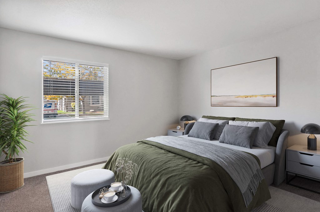 Model Bedroom with Carpet and Window View at Overlook Point Apartments in Salt Lake City, UT.