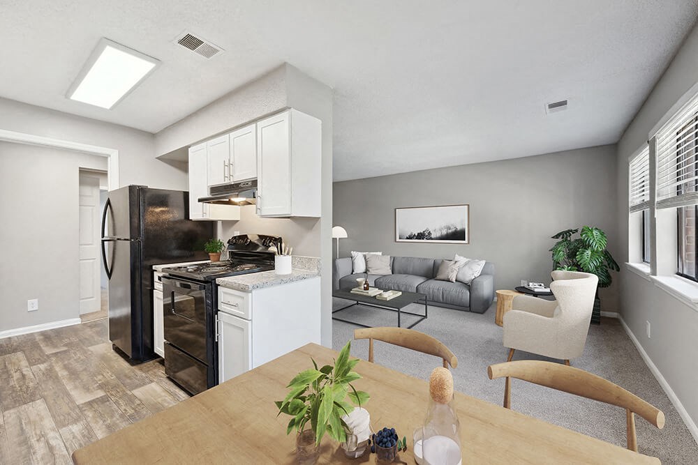 Model Kitchen with White Cabinets and Wood-Style Flooring at Spring Forest Apartments in Raleigh, NC.
