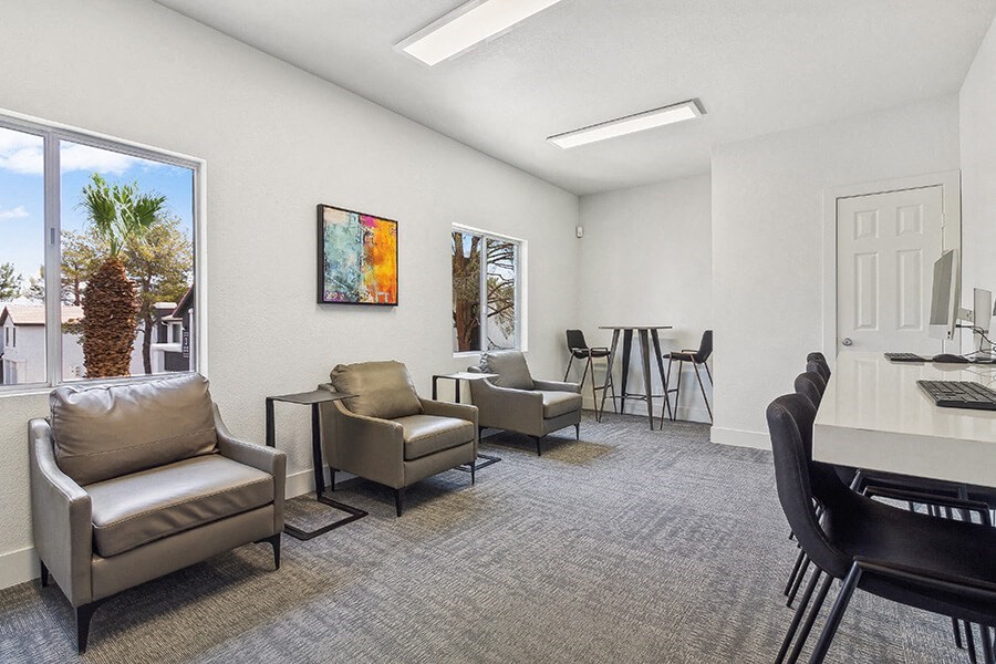 Community Clubhouse with Lounge Furniture and Work Stations at Meadow Ridge Apartments located in Las Vegas, NV.