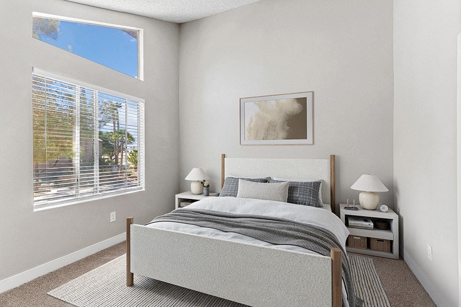 Model Bedroom with Carpet and Window View at Meadow Ridge Apartments in Las Vegas, NV.