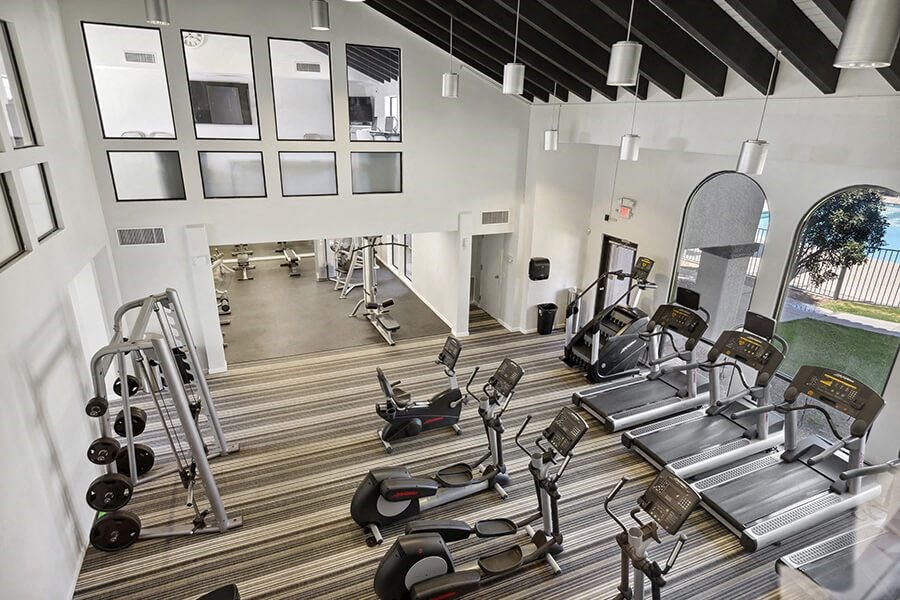 Community Fitness Center with Equipment at Hilands Apartments in Tucson, AZ.