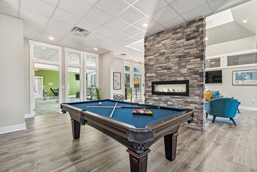 Community area with billiards table and fireplace