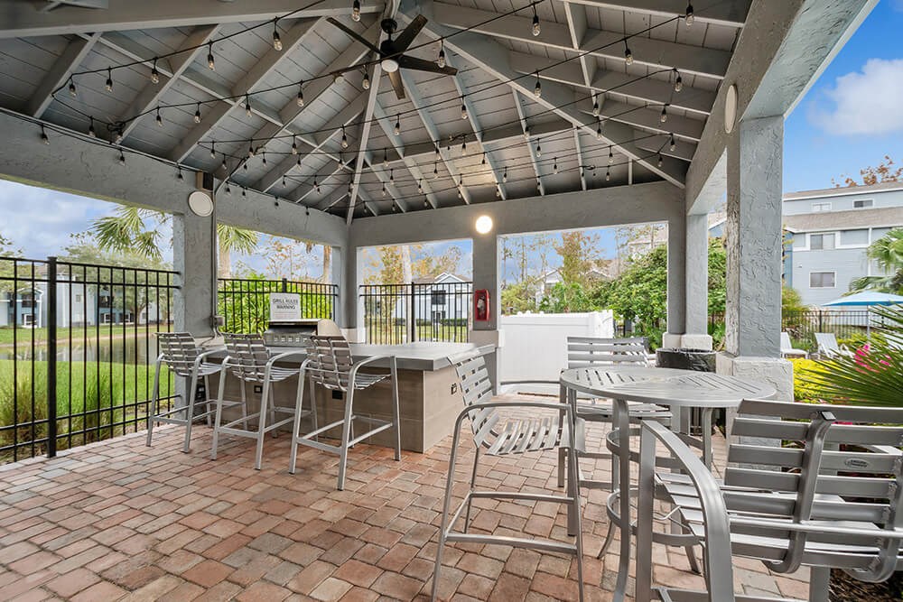 Outdoor BBQ Area with Furniture and Canopy at Westland Park Apartments in Jacksonville, FL.