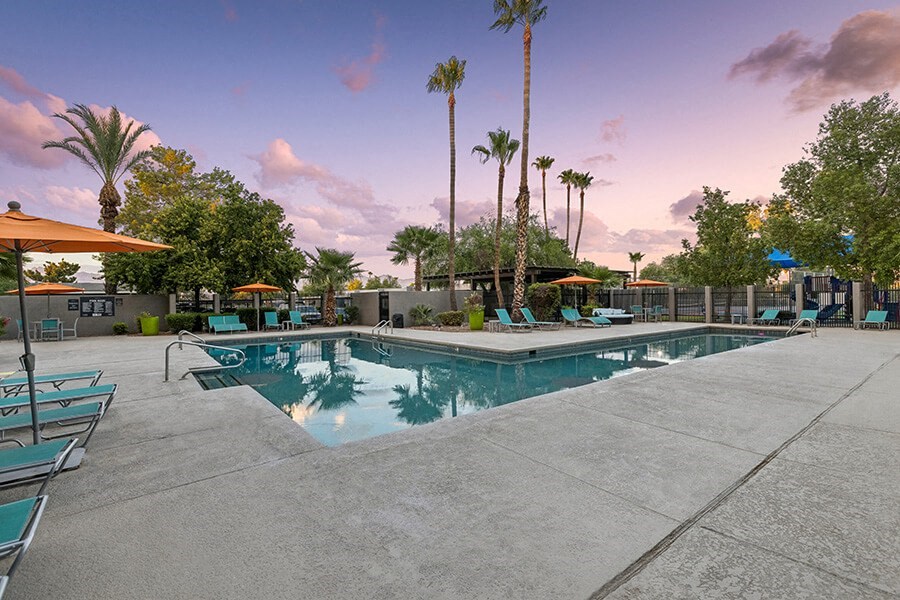 Community Swimming Pool with Pool Furniture at Lakeside Casitas Apartments located in Tucson, AZ.