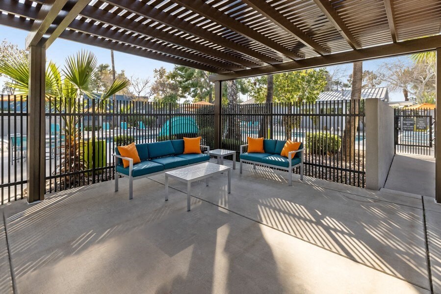A covered patio with two couches and a coffee table at Lakeside Casitas in Tucson, AZ