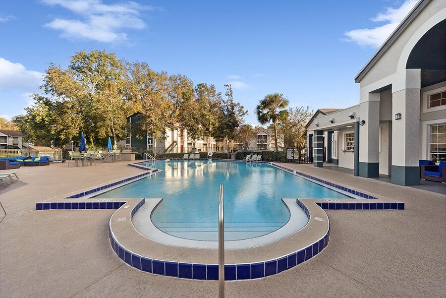 Community Swimming Pool with Pool Furniture at Vue at Baymeadows Apartments in Jacksonville, FL.
