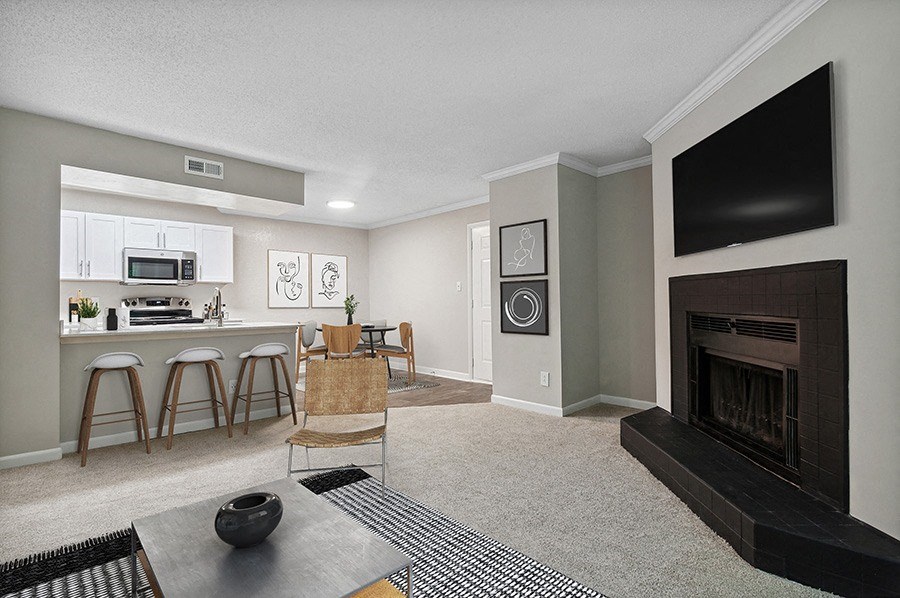 Model Living Room and Dining Room Area with Kitchen View at Arbor Village Apartments in Charlotte, NC.
