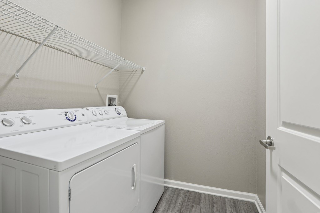 Model laundry room with a white washer and dryer.
