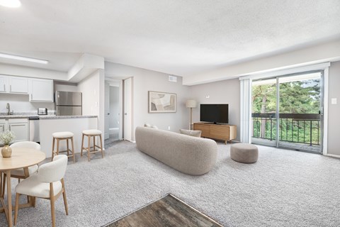 A living room with a couch, a table, and a television.