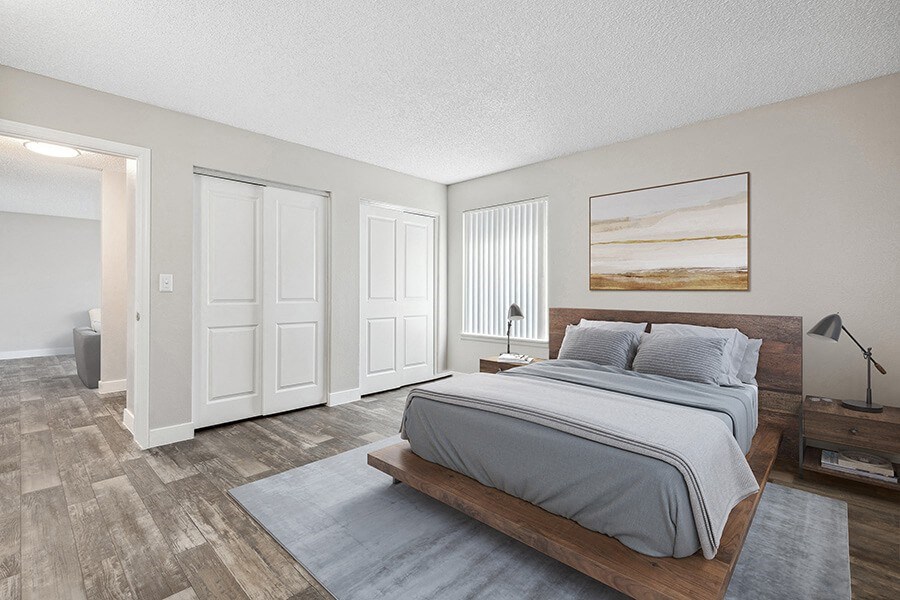 Model Bedroom with Wood-Style Flooring and attached Bathroom at Peaks on 4th Apartments in Avondale, AZ.