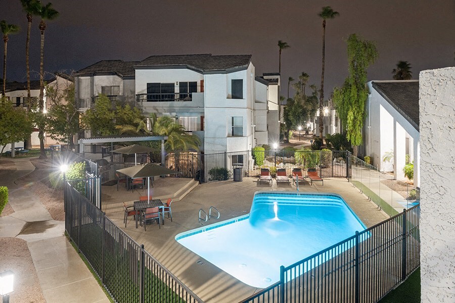 Aerial View of Community Swimming Pool and Pool Furniture at Crystal Creek Apartments located in Phoenix, AZ.