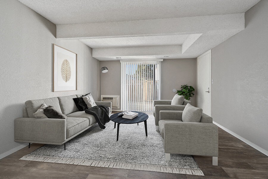 Model Living Room with Wood-Style Flooring and Patio Accessibility at Liberty Creek Apartments in Aurora, CO.