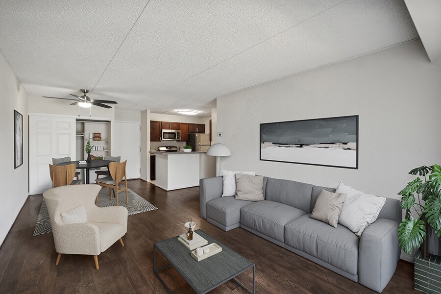 Model Living Room with Wood-Style Flooring and View of Kitchen at Mason Van Dorn Apartments located in Alexandria, VA.