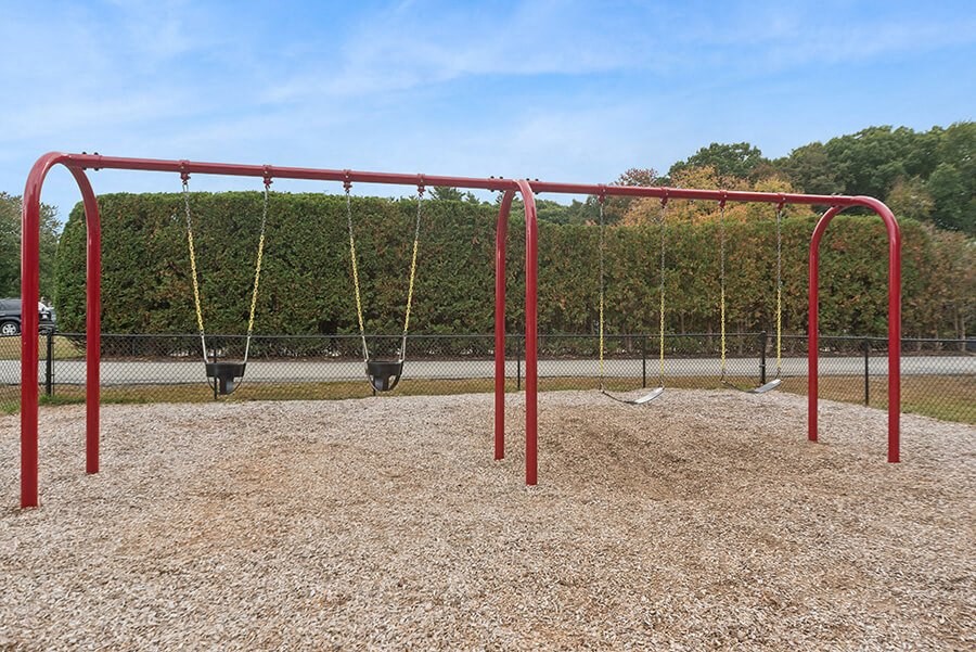 Community Swing Set at Meadows at Marlborough Apartments located in Marlborough, MA.