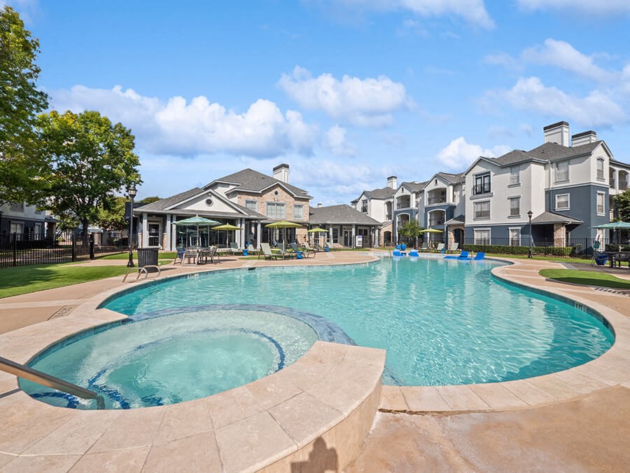 Community Swimming Pool and Hot Tub at Park West Apartments located in Houston, TX.