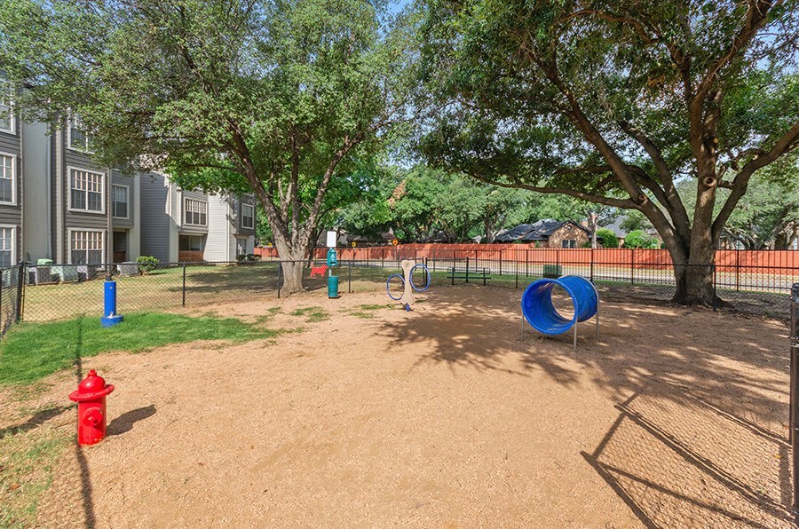 Community Dog Park with Agility Equipment at Cobblestone Apartments located in Arlington, TX.