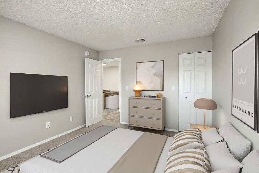 Model bedroom with a bed and a dresser