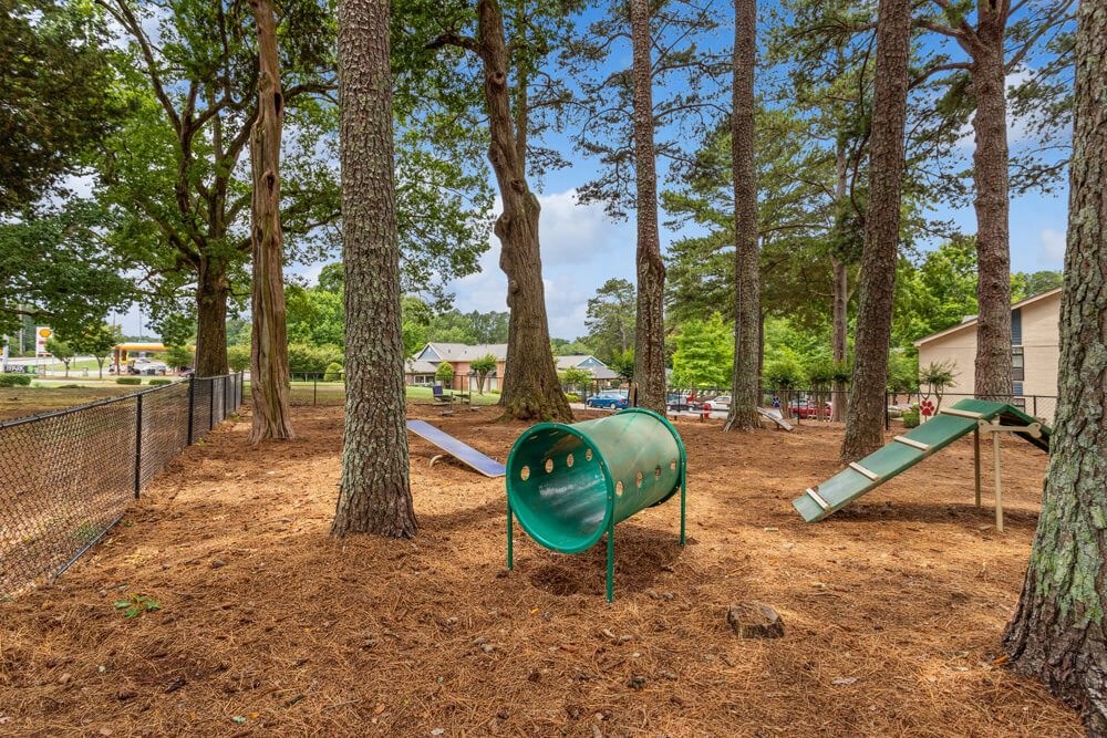 a playground with a slide and a seesaw in a park