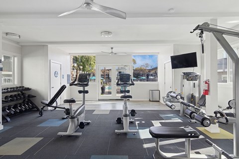 San Jose, CA, Pet-Friendly Affordable Apartments - Los Gatos Landing - A Fitness Center With Stationary Bikes, Weight Benches, And Dumbbell Rack.