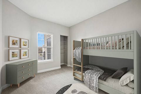 A bedroom with a bunk bed and a dresser.