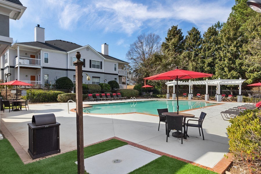 Community clubhouse and pool area with loungers and tables