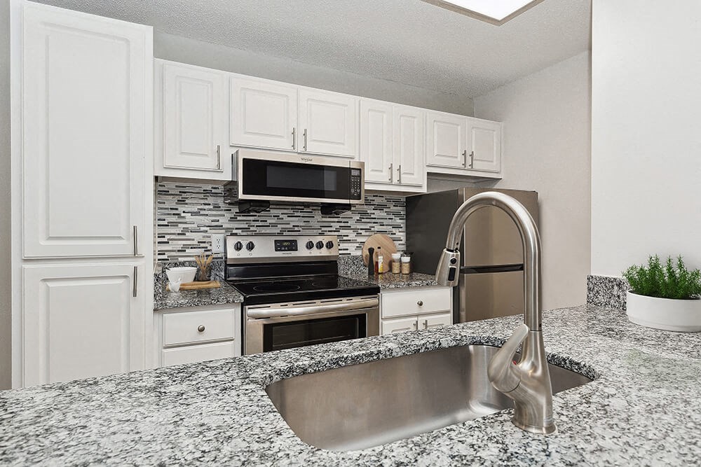 Model Kitchen with White Cabinets at Seven Lakes at Carrollwood Apartments in Tampa, FL.