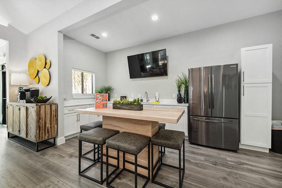 Community Clubhouse Kitchenette with Island Bar at Bridges at Deer Run Apartments in Dallas, TX.