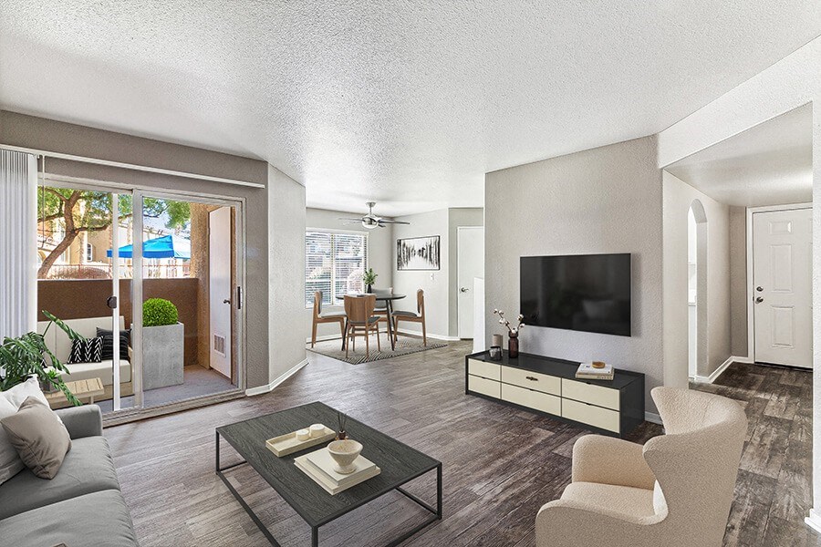 Model Living Room with Wood-Style Flooring and Patio Accessibility at Topaz Springs Apartments in Las Vegas, NV.