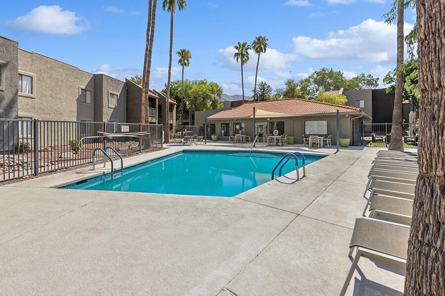 Community Swimming Pool with Pool Furniture at Saddle Ridge Apartments in Tucson, AZ.