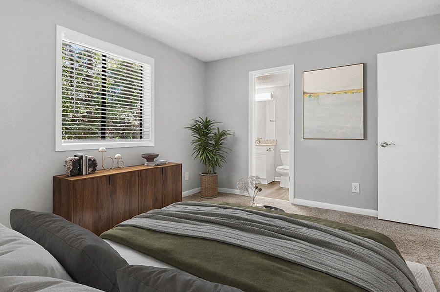 Model Bedroom with Carpet and attached Bathroom at Stoney Trace Apartments in Charlotte, NC.