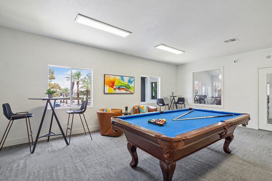 Community Clubhouse with Game Tables and Lounge Furniture at Meadow Ridge Apartments located in Las Vegas, NV.