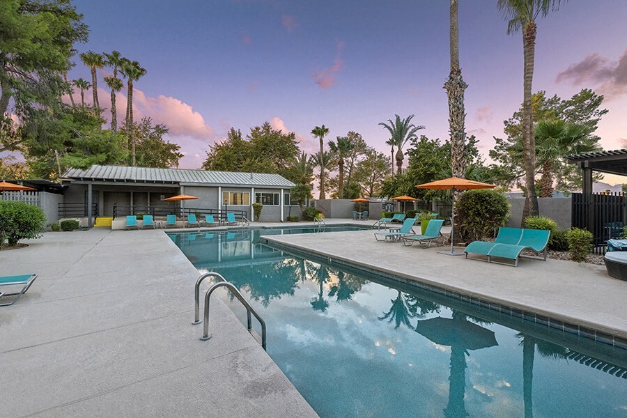 Community Swimming Pool with Pool Furniture at Lakeside Casitas Apartments located in Tucson, AZ.